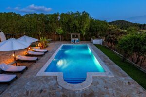 Luxury villa in Morna Valley, Santa Eulalia with 5 bedrooms, pool, Balinese bed, lush garden, and fruit trees, ideal for long-term rental in Ibiza.