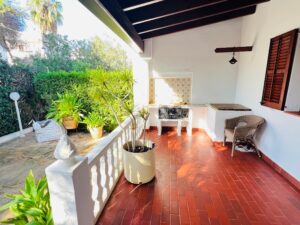Luxury Mediterranean villa outdoor seating area with garden views in Santa Eulalia del Rio.