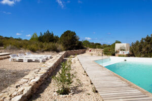 Exterior view of Casa Daniela in Formentera, a luxury villa rental with a private pool, garden, and stunning views of Ibiza and the Formentera countryside.