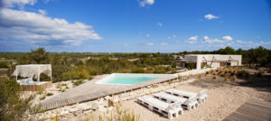 Exterior view of Casa Daniela in Formentera, a luxury villa rental with a private pool, garden, and stunning views of Ibiza and the Formentera countryside.