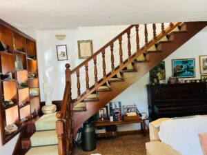 Elegant staircase leading to the second floor with Mediterranean-style details.