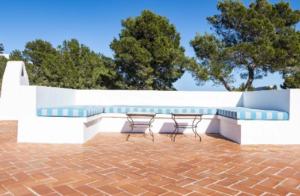 Exterior view of Casa Nashamena in San Miguel, Ibiza, showcasing a private pool, lush gardens, and panoramic views.
