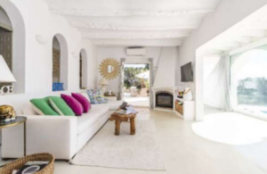 Spacious living room interior of Casa Nashamena with natural light and elegant decor.
