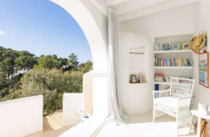 Spacious living room interior of Casa Nashamena with natural light and elegant decor.