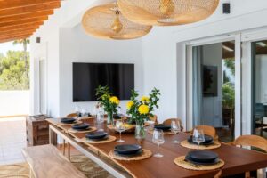 Outdoor dining area at Luxury Casa Flamenc, Ibiza, beautifully decorated for daytime meals with a relaxing ambiance.