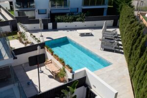 Aerial view of the private pool at Luxury Villa Jesús, Ibiza, showcasing the expansive outdoor area and clear turquoise water.