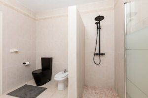 Modern bathroom at Luxury Casa Flamenc, Ibiza, featuring a sleek shower, elegant fixtures, and contemporary design.