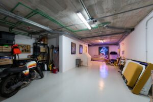 Spacious and modern garage at Luxury Villa Jesús, Ibiza, featuring ample parking space and contemporary design.