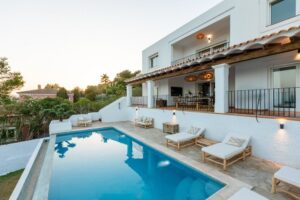 Stunning private pool at Luxury Casa Flamenc, Ibiza, featuring crystal-clear water, modern design, and lush outdoor surroundings.