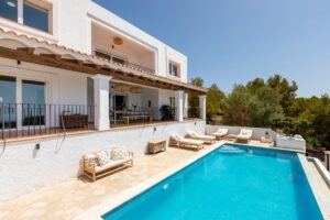 View of the private pool and the front of Luxury Casa Flamenc, Ibiza, highlighting the modern architecture and outdoor space.