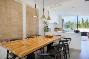Elegant indoor dining room at Luxury Villa Jesús, Ibiza, featuring a modern dining table, stylish chairs, and sophisticated décor.