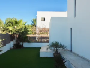 Modern entrance of luxury villa in Can Besso, Ibiza with sleek architecture and tropical landscaping