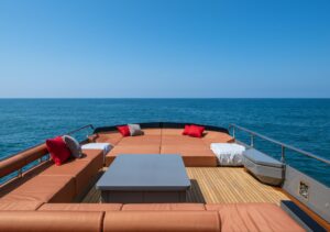 Spacious flybridge sundeck lounge on AB 80 motor yacht with sunpads and seating