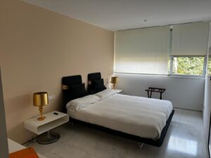Master bedroom with en suite bathroom and sea view at Es Pouet Talamanca Ibiza